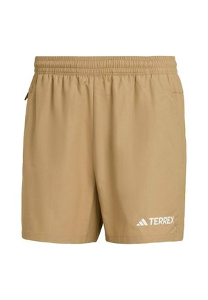 Shorts beiges en tissu léger avec une taille élastique, dotés de poches latérales et d'un logo "TERREX" blanc sur le bas à gauche.