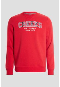Sudadera de algodón roja con cuello redondo, que presenta el texto "CREEKS ORIGINAL Desde 1974" en blanco y azul marino, y puños y dobladillo de canalé.