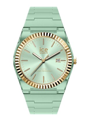 Miętowo-zielony zegarek na nadgarstek ze złotą lunetą, złotymi indeksami godzin, trzema wskazówkami oraz datownikiem ustawionym na 2:00, pokazujący czas 10:10:36.