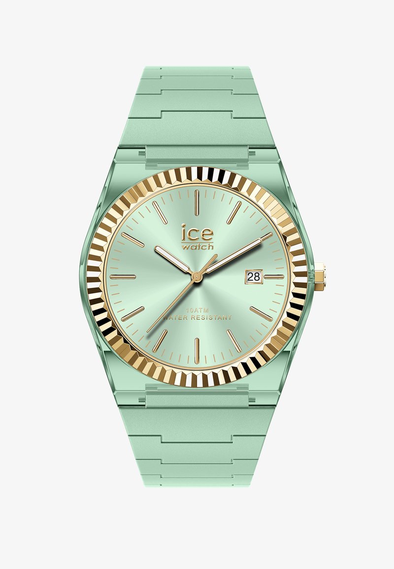 Miętowo-zielony zegarek na nadgarstek ze złotą lunetą, złotymi indeksami godzin, trzema wskazówkami oraz datownikiem ustawionym na 2:00, pokazujący czas 10:10:36.