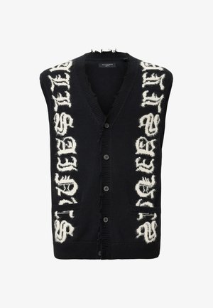 Gilet en tricot noir avec lettrage blanc vieilli, encolure en V, fermeture à boutons et deux poches avant. Tissu texturé avec des bords effilochés.