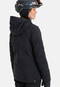 Black insulated jacket with a hood, featuring a smooth texture, back seam detail, and a small logo accent at the hem.
