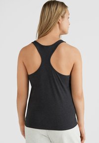 Ciemnoszara koszulka na ramiączkach w stylu racerback, wykonana z miękkiego materiału, charakteryzująca się gładką teksturą i okrągłym dekoltem oraz niskimi armhole'ami, zapewniającymi swobodę ruchów.
