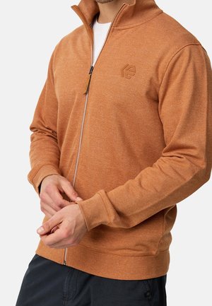 Oranje zip-up sweatshirt van structuurtstof. Heeft een hoge kraag, ribgebreide boorden en een klein logo op de linkerborst.