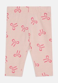 Helle rosa Leggings aus weichem Stoff, mit einem wiederholten Muster von kontrastierenden, leuchtend pinken Schleifen. Elastischer Bund für zusätzlichen Komfort.