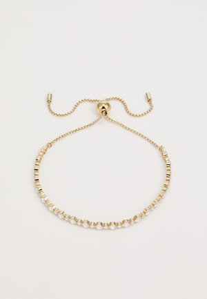 Kuldtooni käevõru, mis koosneb vahelduvatest ristkülikukujulistest metallist linkidest ja diamanthõngulistest kivikestest ning millel on reguleeritav ahelvank.