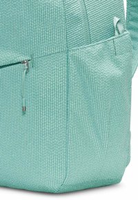 Light mint green textured backpack featuring a zippered pocket and adjustable straps. Made from durable material with a patterned surface.
