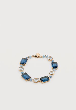 Gold bracelet with alternating rectangular dark blue and round light blue gemstones linked by small blue beads.