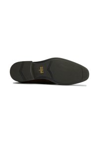 Black shoe sole with textured rubber surface, hexagonal pattern, and gold "SOLE 8" branding near heel. Flat design with slight heel elevation.