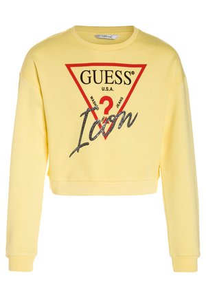 Gelbes, kurz geschnittenes Sweatshirt mit einem roten dreieckigen Grafikmotiv und schwarzem Text mit den Worten "GUESS" und "Icon", akzentuiert durch ein "?" und ein strukturiertes Muster.