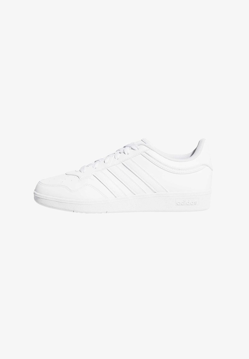 White athletic shoe with a smooth leather-like upper, featuring three narrow stripes and a textured sole for grip.
