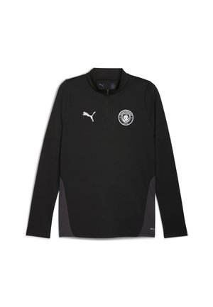 Sort langærmet trøje med halv lynlås i kraven, med et hvidt Puma-logo og Manchester City-emblem på brystet. Glat tekstur.