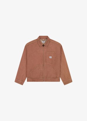 Chaqueta de mezclilla color óxido con cremallera frontal, cuello puntiagudo y un bolsillo en el pecho izquierdo. Cuenta con dos grandes bolsillos frontales y mangas largas.