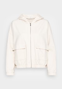 Bílá mikina na zip vyrobená z měkkého materiálu, s kapucí, dvěma předními kapsami a elastickými manžetami a lemem pro uvolněný střih.