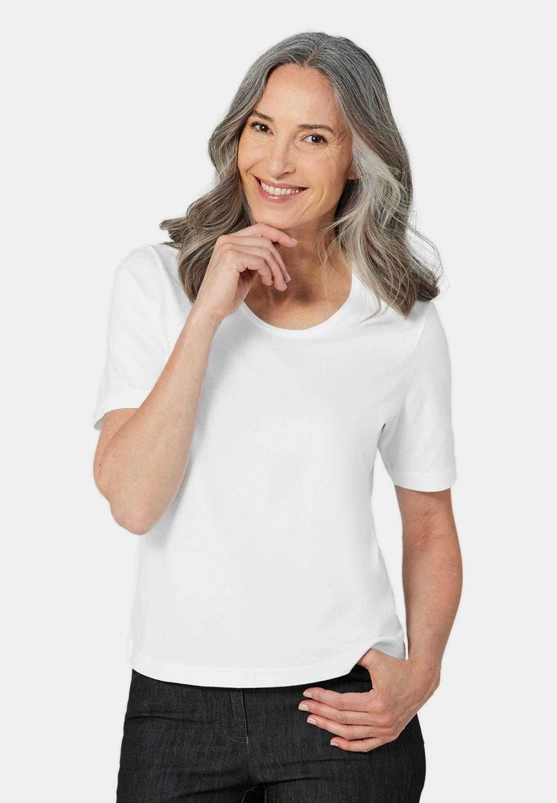 Witte t-shirt met korte mouwen en een ronde halslijn. Gemaakt van zachte stof, heeft het een ontspannen pasvorm en schone randen.