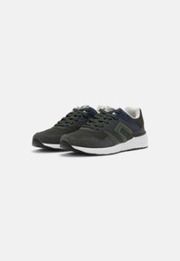 Dark green athletic shoes with a textured fabric upper, contrasting navy accents, and a white sole. Rounded toe and lace-up design.