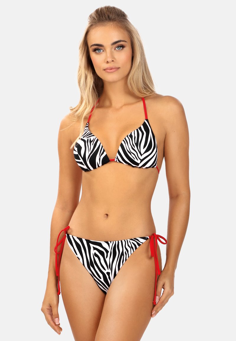 Czarny i biały bikini w pasy zebry z czerwonymi ramiączkami i zapięciami. Trójkątny stanik i majtki hipster. Gładka tekstura, lekki materiał.