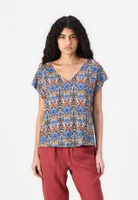 Short-sleeve top with a V-neck, featuring a colorful floral pattern in blue, red, and black on a beige background. Lightweight fabric.