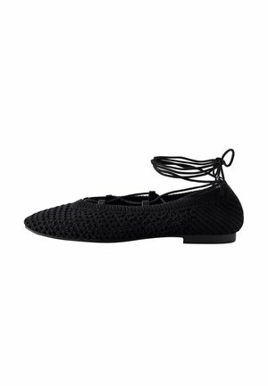 Black knitted ballet flat with a pointed toe, featuring lace-up ankle straps and a sleek, minimal design. Flat sole for easy wear.