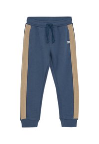 Blaue Jogginghosen mit beigen Seitenstreifen, elastischem Bund mit Kordelzug, Bündchen am Knöchel und einem kleinen Logo-Patch auf der Vorderseite.