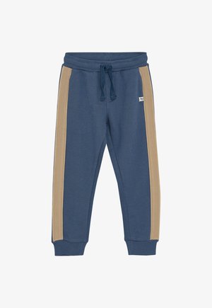 Pantalon de jogging bleu avec des rayures beige sur les côtés, taille élastique avec cordon de serrage, chevilles resserrées et un petit logo devant.