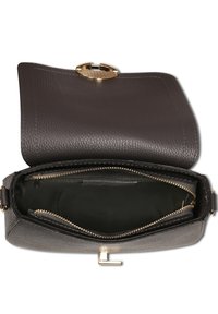 Brown leather handbag with a textured surface, gold-tone hardware, zippered interior pockets, and a structured shape. Interior features a dark lining.