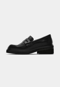 Black leather loafers with a rounded toe, a front strap accent, and a chunky block heel. Smooth texture with minimal stitching detail.