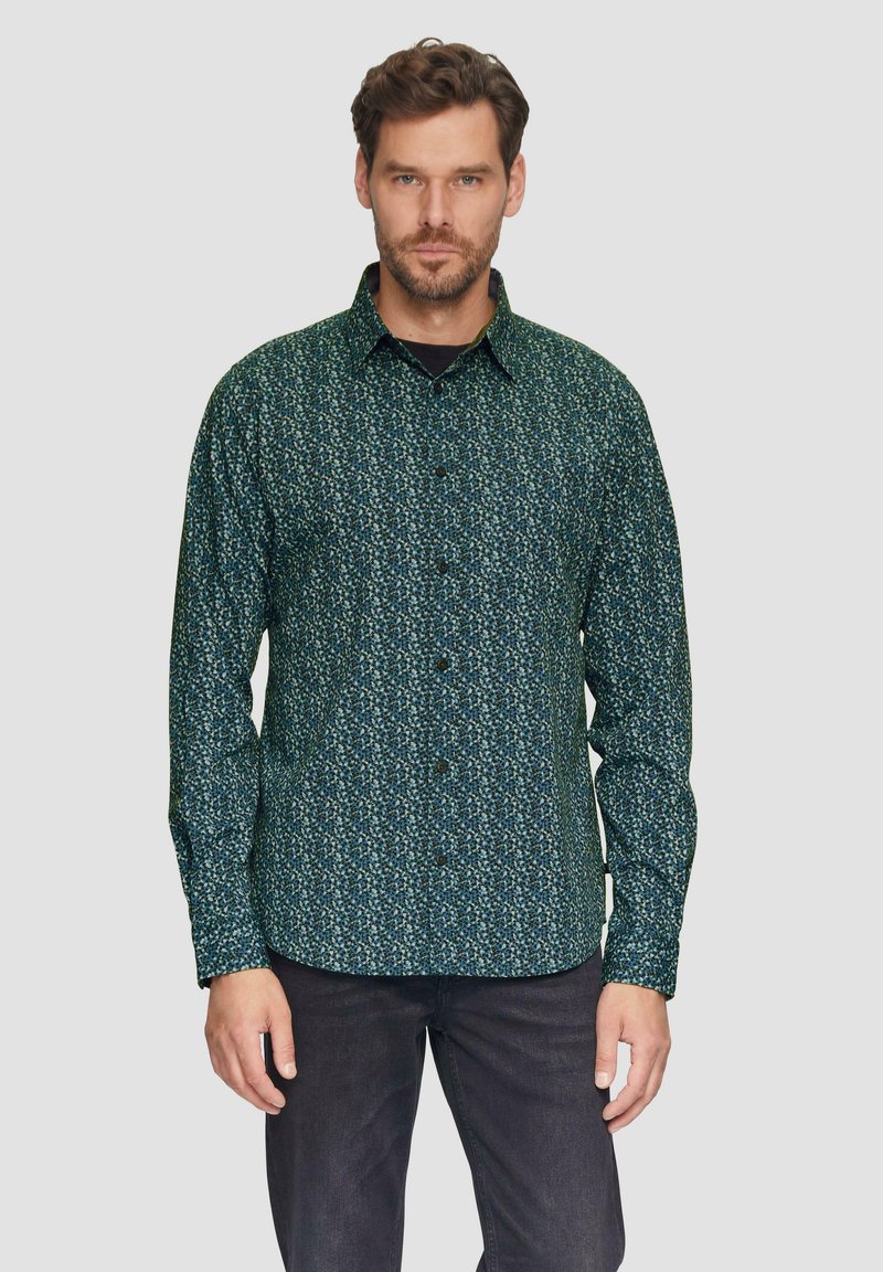 Donker groene overhemd met een klein, abstract patroon in lichtere tinten. Lange mouwen, kraag en een gebogen zoom.