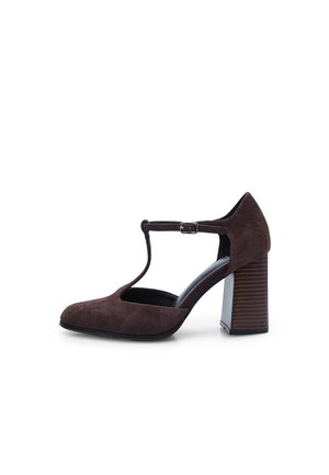 Brown suede high-heeled pump with a t-strap and buckle detail, featuring a square toe and a wooden-textured block heel.