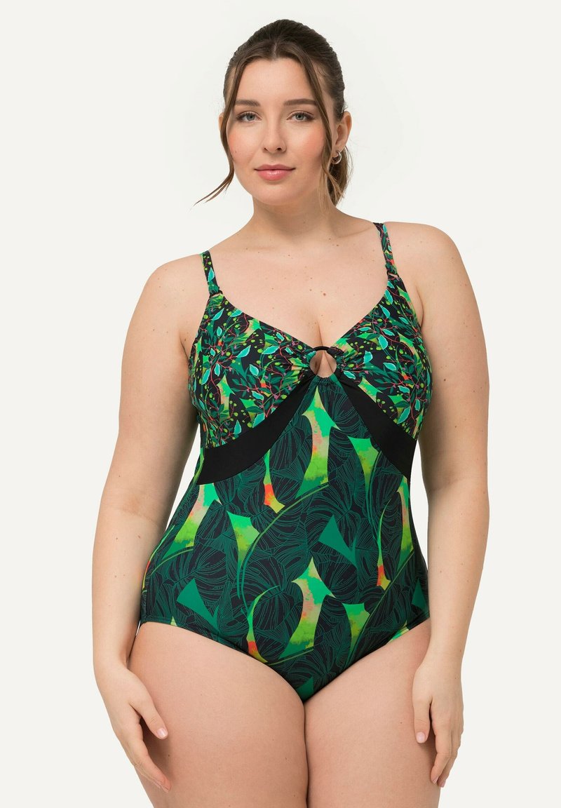 Maillot de bain une pièce avec un motif de feuilles tropicales vertes, des accents noirs et un design en forme de trou de serrure au niveau de la poitrine. Bretelles ajustables. Texture lisse.