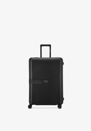 Black hard-shell suitcase with vertical ridges, a retractable handle, four wheels, and a front strap with a circular lock.