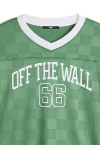 Green checkered t-shirt with a white V-neck collar. Features "OFF THE WALL" in bold white font and "66" below in white outlined text.
