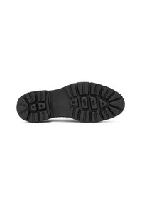 Suela de zapato de goma negra con surcos profundos y ranuras de amortiguación, que presenta una superficie lisa y sólida sin logotipos ni patrones visibles.