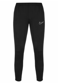 Pantalons de sport noirs en tissu doux et extensible. Dotés d'une taille élastique et d'un logo Nike blanc sur la cuisse gauche.