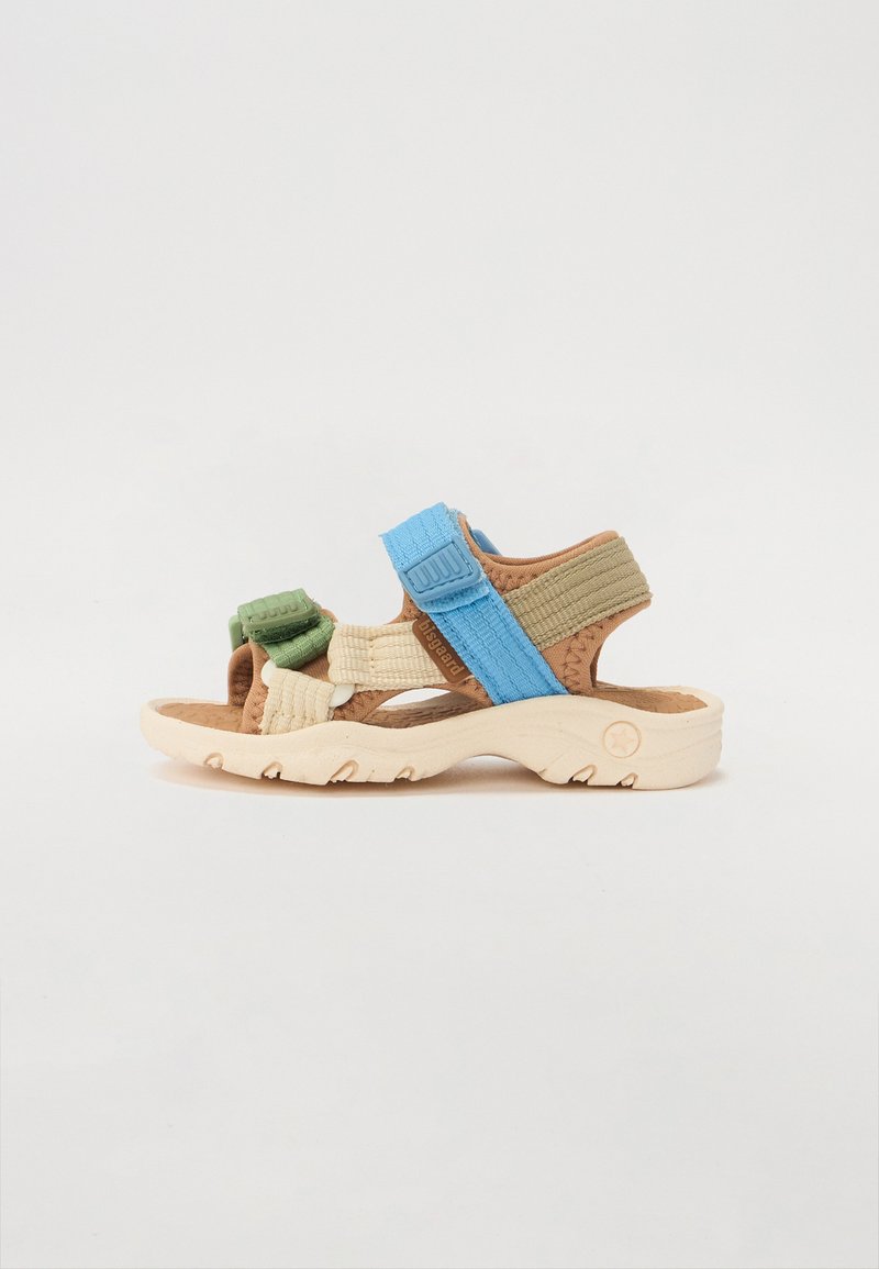 Multi-colored sandal featuring brown, green, and blue straps, textured fabric materials, and a light beige rubber sole with traction details.