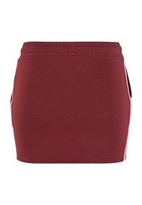 Burgundská bavlnená sukňa s elastickým pásom a ružovými bočnými pruhmi. Má rovný strih a žiadne ozdoby ani vzory.