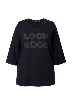 Černé tričko s krátkými rukávy s nápisem "LOOK GOOD" v dekorativním písmu. Vyrobeno z měkké látky s volným střihem.