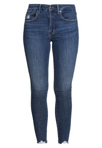 Smala jeans i mörkblå denim med en lätt blekt textur. Har framfickor, dragkedja och slitna fållar.