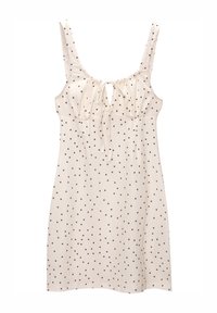 Vestido beige claro con lunares negros, que presenta un escote redondeado, detalle de atado ajustable y tirantes delgados. Tejido texturizado.