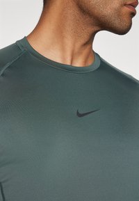 Nike Performance SLIM TOP - T-Shirt sport - vintage green/black