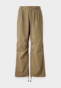 Khaki wide-leg trousers made from textured fabric. Features two front pockets and adjustable drawstrings at the ankles.
