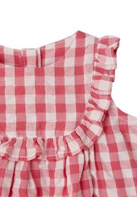 Red and white gingham dress neckline with ruffled trim and button closure, made from a lightweight cotton fabric.