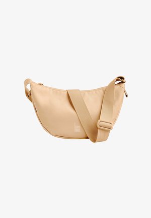 Sac bandoulière beige avec une forme courbée, fermeture éclair et sangle en tissu réglable. Présente un motif de logo sur la surface.