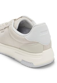 Αθλητικό παπούτσι από γκρι σουέντ με λείες λευκές δερμάτινες λεπτομέρειες, υφασμένο εξωτερικό πέλμα και επενδυμένο κολάρο. Διαθέτει διακριτικό λογότυπο στη φτέρνα.