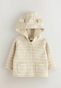 Veste bébé beige avec capuche, dotée de deux petites oreilles en tissu, poches avant et boutons-pression au centre.