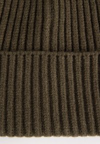 Ribbed knit fabric in deep olive green, featuring a textured surface with prominent vertical lines and a soft, fuzzy appearance.