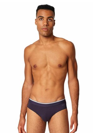 Heren slip in donkerblauwe stof met een gladde textuur. Voorzien van een contrasterende lichtgrijze tailleband. Strak model zonder patronen.