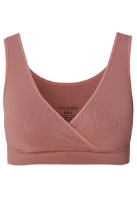 Trådlös bralette i persikofärg med ribbat tyg, som har en korsad framsida och en bred band för stöd.