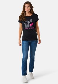 Black short-sleeve t-shirt with a gray mountain and tree graphic, featuring a pink moose and the text "Outdoor Expedition" in pink.