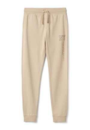 Beige joggingbroek gemaakt van zachte stof, met een elastische tailleband met trekkoord, zijzakken en bedrukt tekst op het linkerbeen.